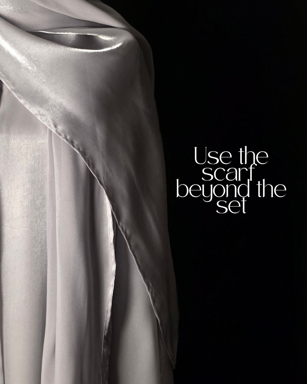 Silver scarf draped over a black background with text 'Use the scarf beyond the set'.